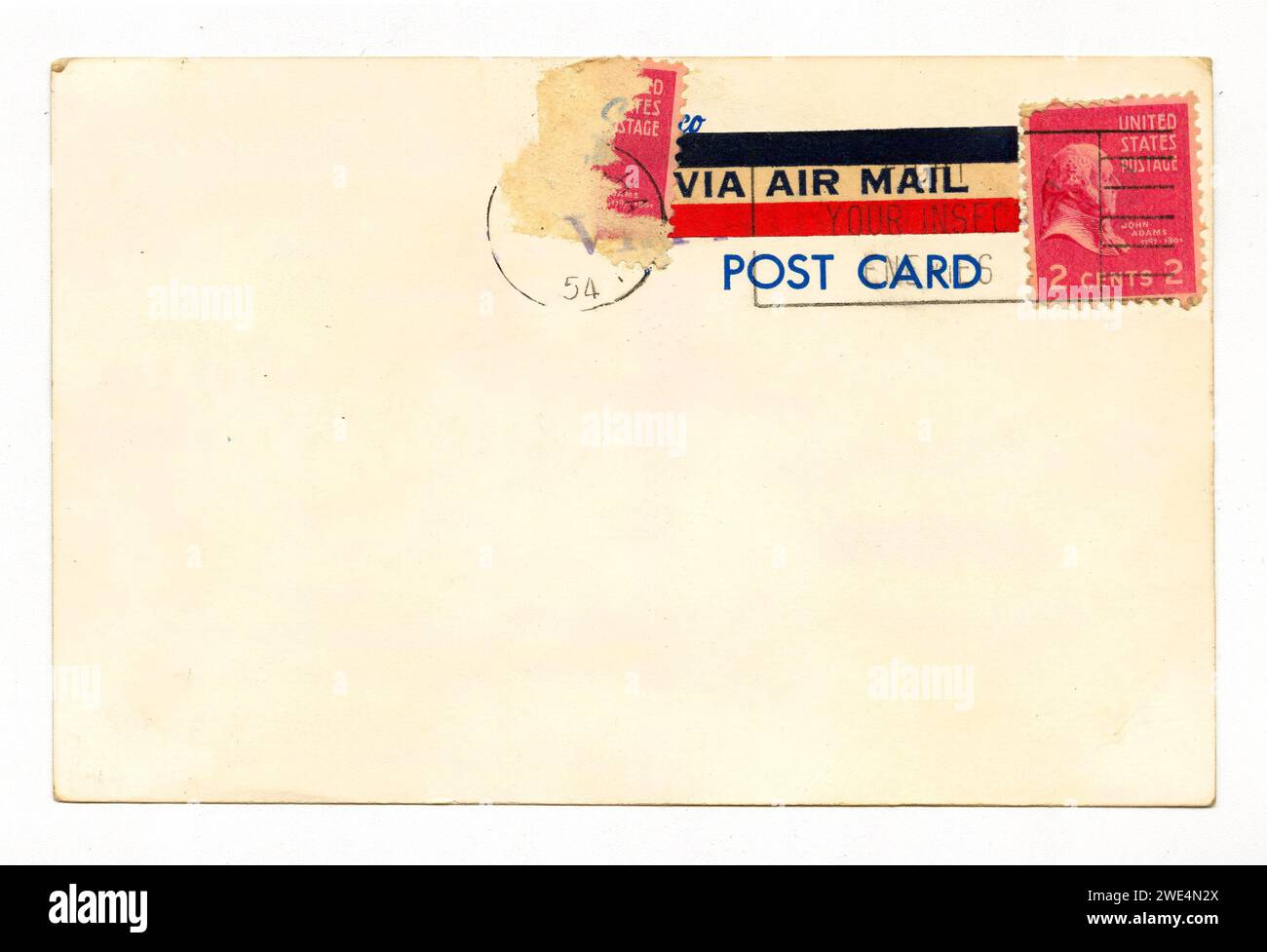 Blank vintage postcard back with 2¢ US postage stamps and air mail stickers, postmarked 1954 Stock Photo