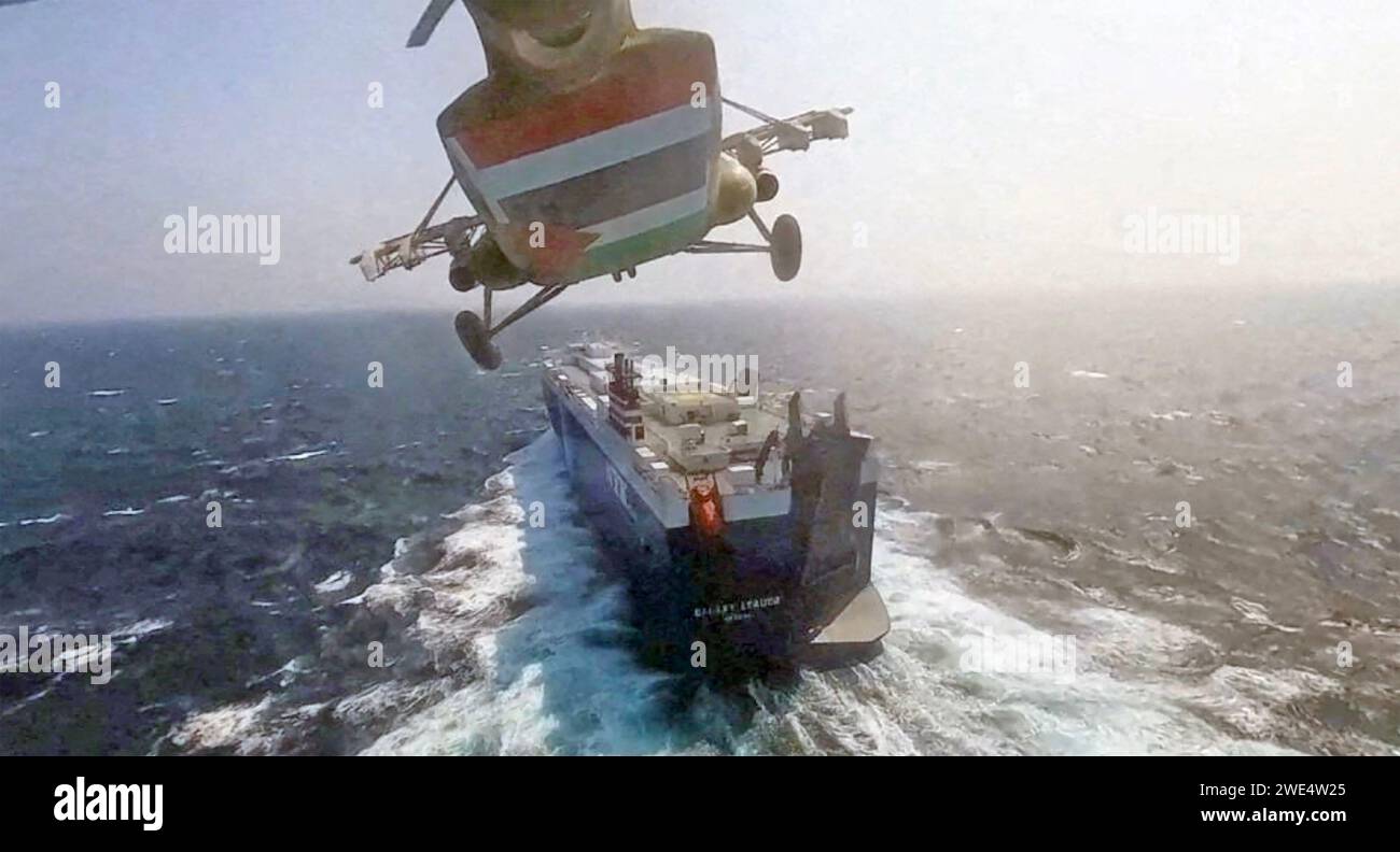 HOUTHI HELICOPTER approaching the cargo ship Galaxy Leader on Sunday 19 November 2023  in the Red Sea off the coast of Yemen to land armed hijackers. Stock Photo
