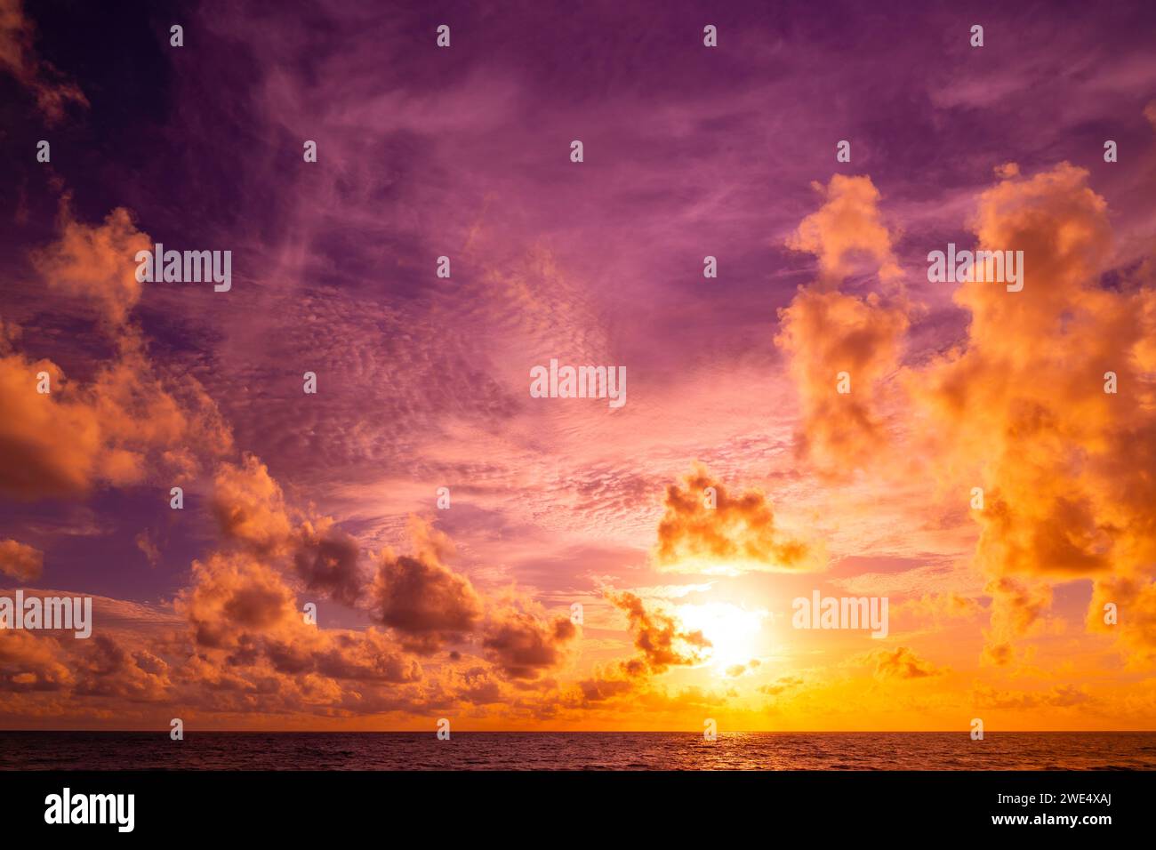 Beautiful colorful sunset or sunrise sky over sea with dramatic clouds ...