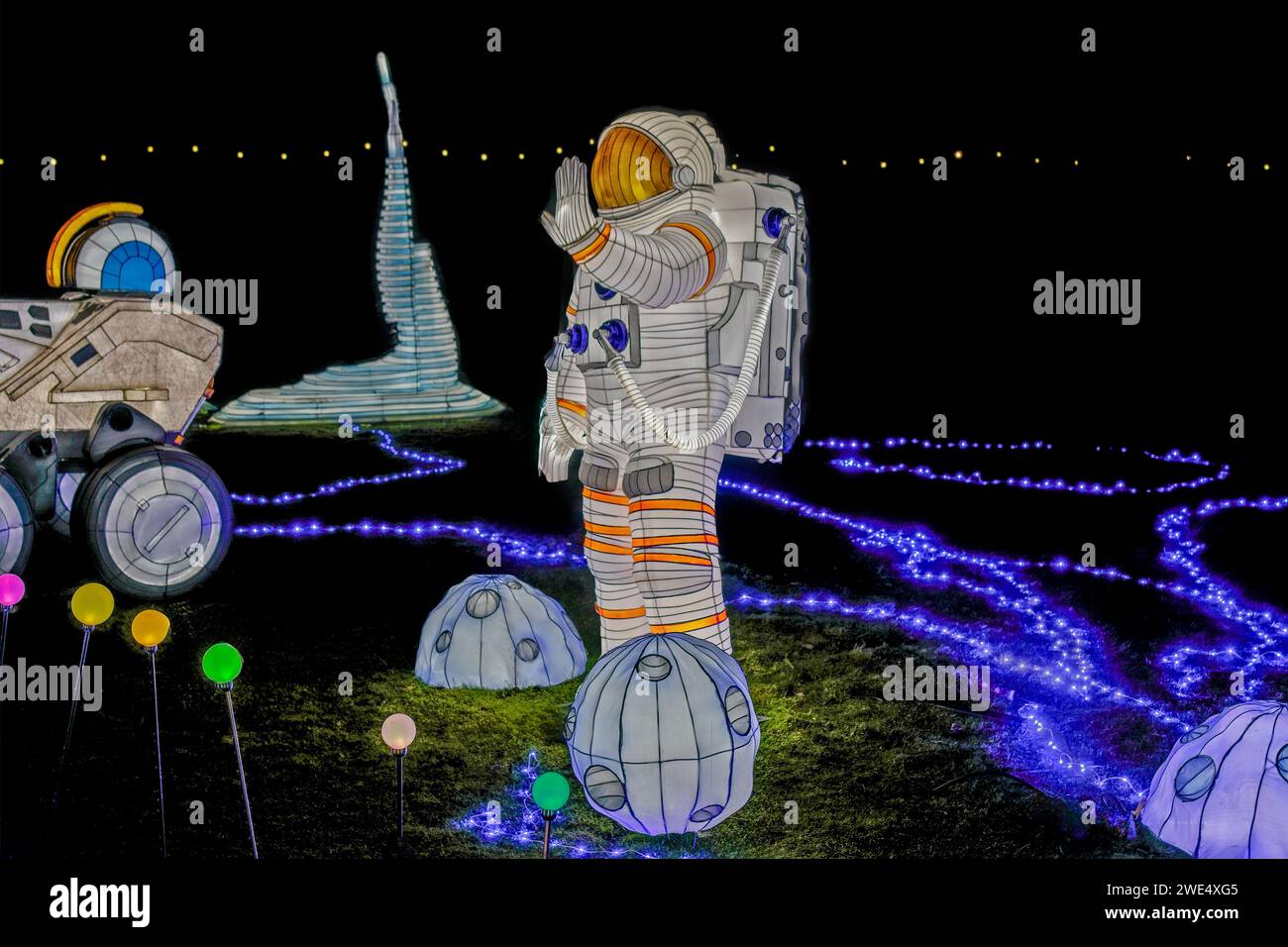 A futuristic astronaut is encircled by a dazzling array of blue lights during the Winter Illuminations at Yorkshire Wildlife Park,Branton,Yorkshire. Stock Photo