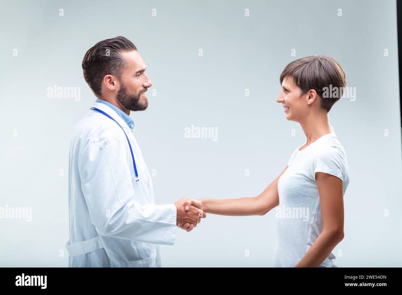 Skilled doctor's empathy cements a patient's feeling of security after successful treatment Stock Photo