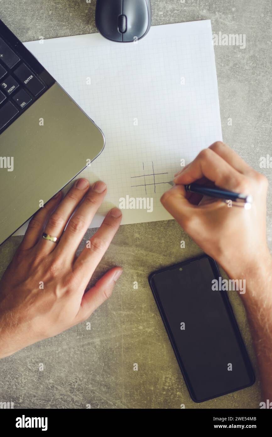 person using laptop, working and taking notes Stock Photo
