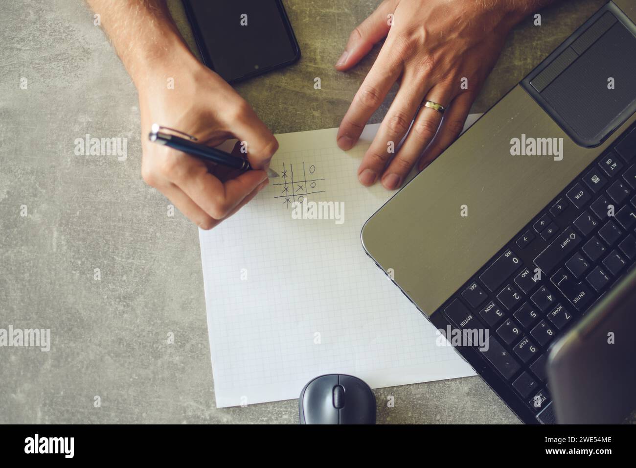 person using laptop, working and taking notes Stock Photo
