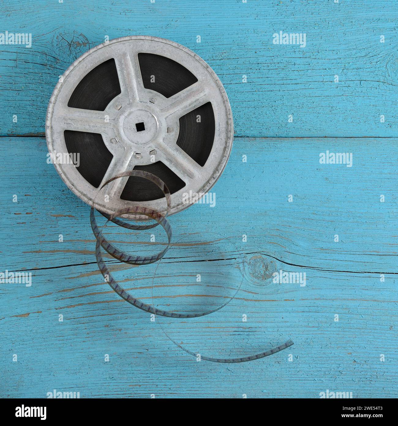 Old film strip on wooden blue background. Stock Photo