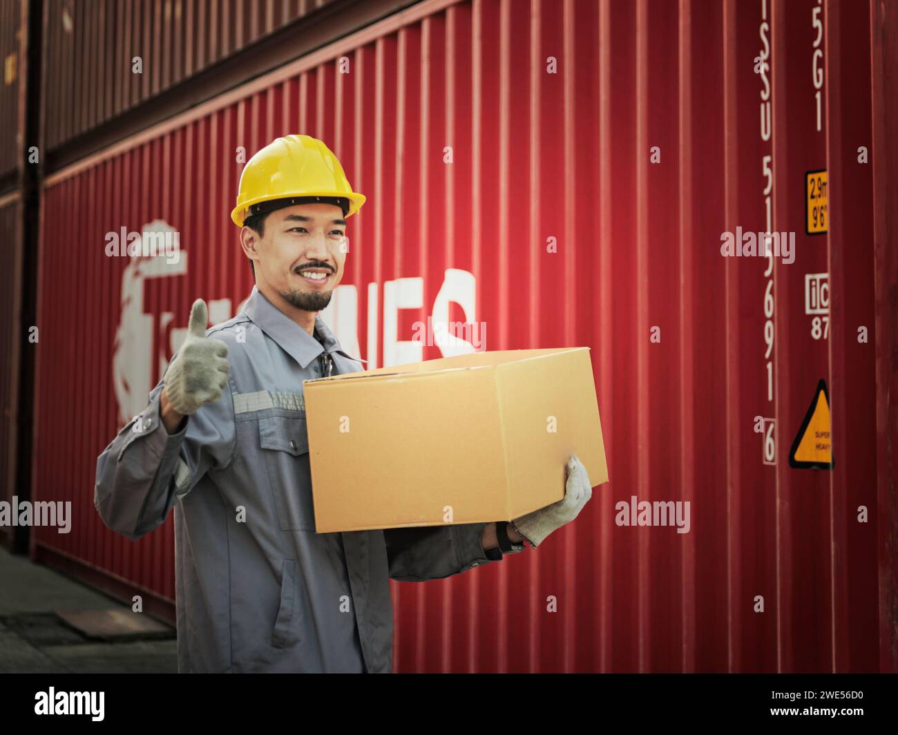 Engineer worker hold cardboard box packaging showing thumbs up on
