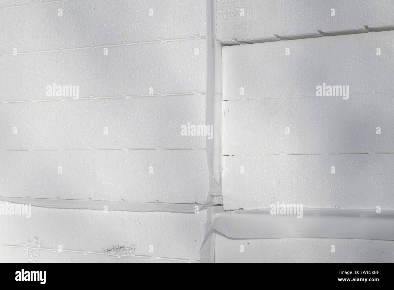 Stack of styrofoam insulation boards on construction site, selective focus Stock Photo