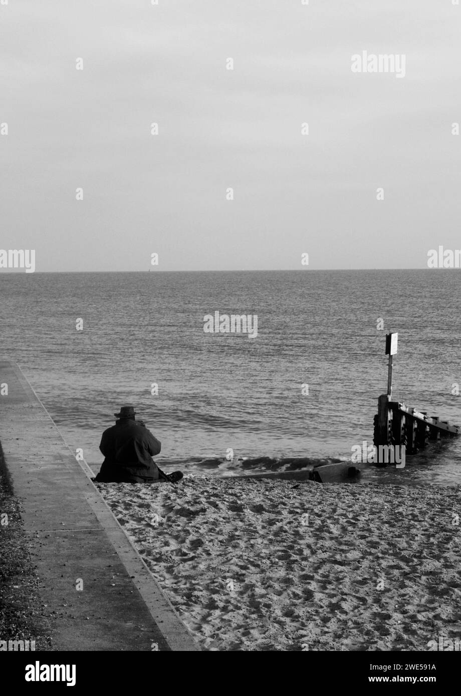 Man on beach, Felixstowe, Suffolk Stock Photo