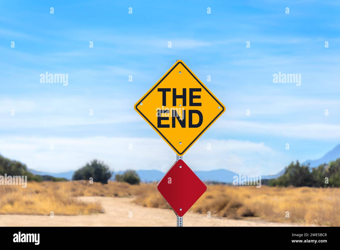 The End street sign in the Mojave Desert with blue sky Stock Photo