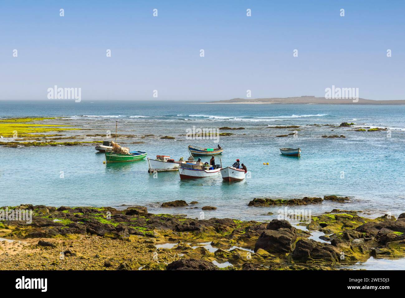 Boa Vista, Cape Verde- March 22, 2018: A peaceful harbor scene with colorful boats in Sal Rei serene waters Stock Photo