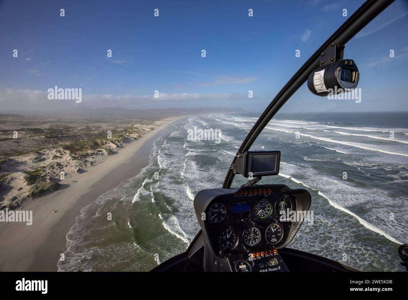 Aerial view through the windscreen of a helicopter over the coast and beach at Walker Bay Nature Reserve, Gansbaai De Kelders, Western Cape, South Afr Stock Photo