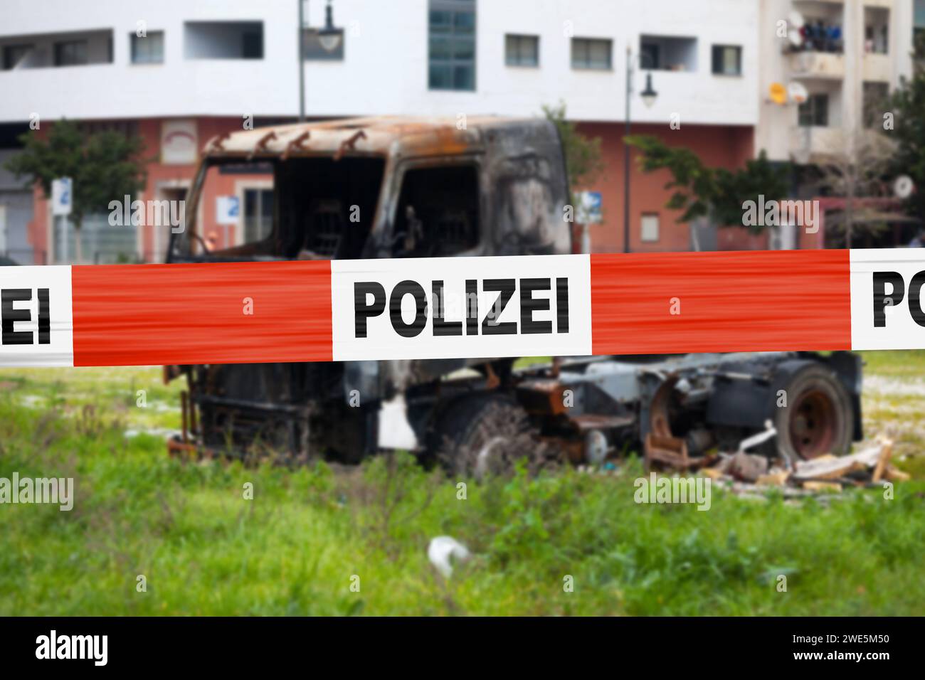Truck burnt by a pyromaniac with a police tape with written in it in German 'Polizei'. Stock Photo
