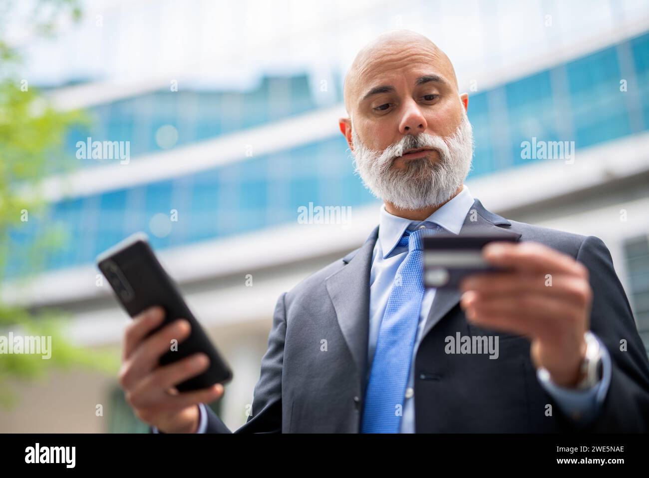 Businessman using his credit card and his cellphone, online purchase concept Stock Photo