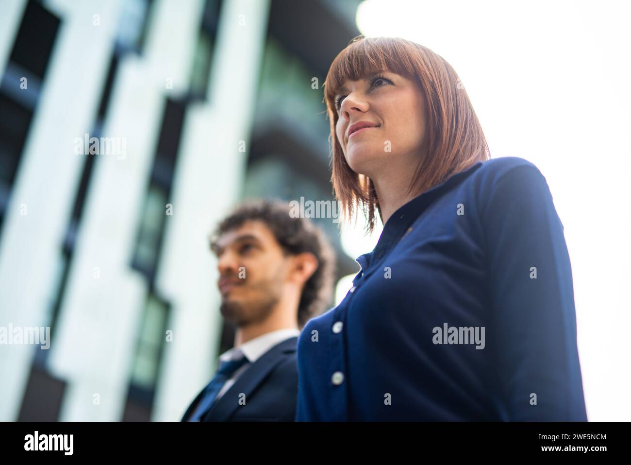 Smiling business people walking in a city Stock Photo - Alamy