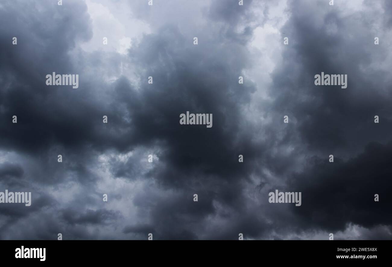 Dark stormy sky with grey clouds background. Stock Photo