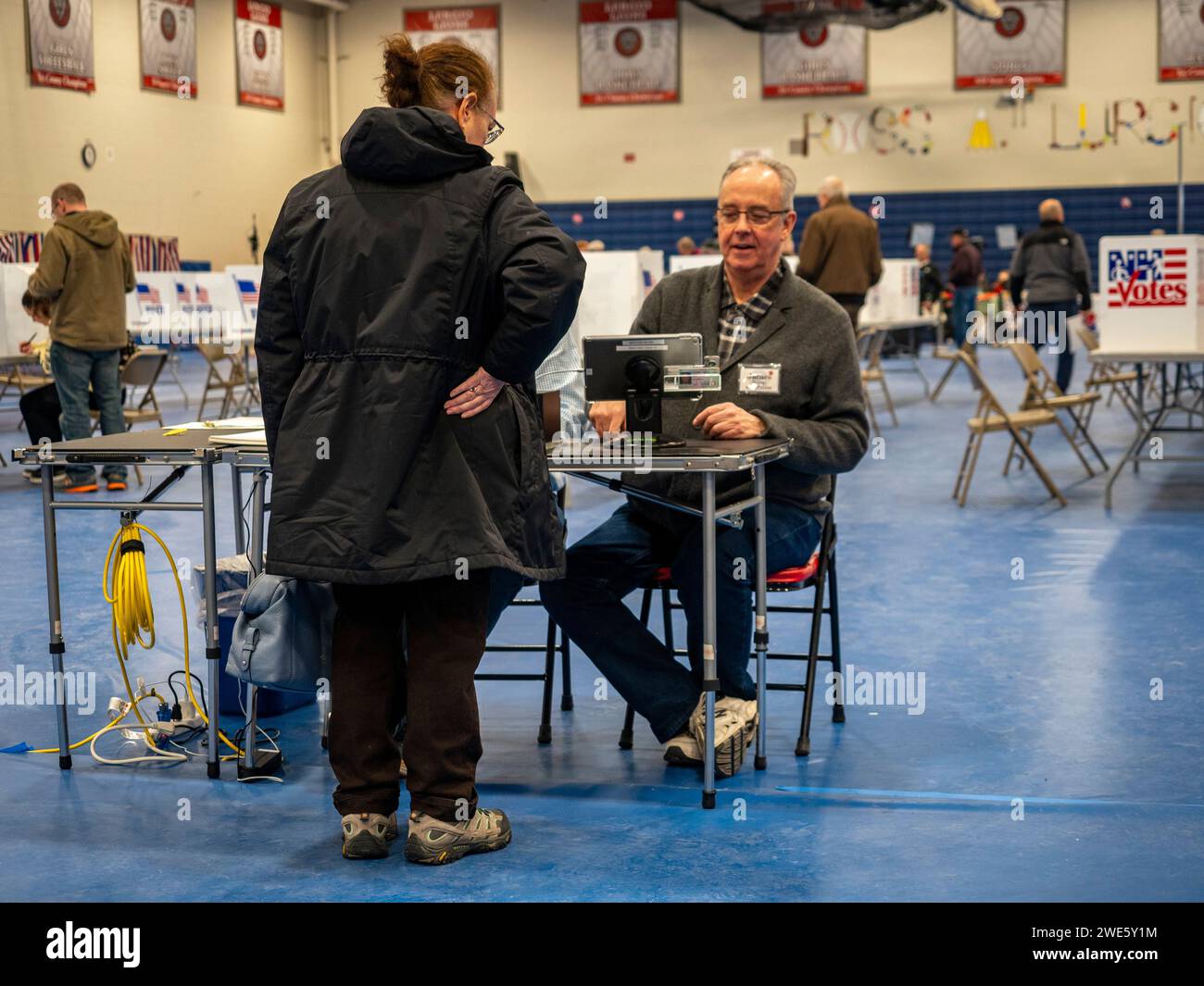 Bedford, New Hampshire, USA. 23rd Jan, 2024. A voter checks in to cast