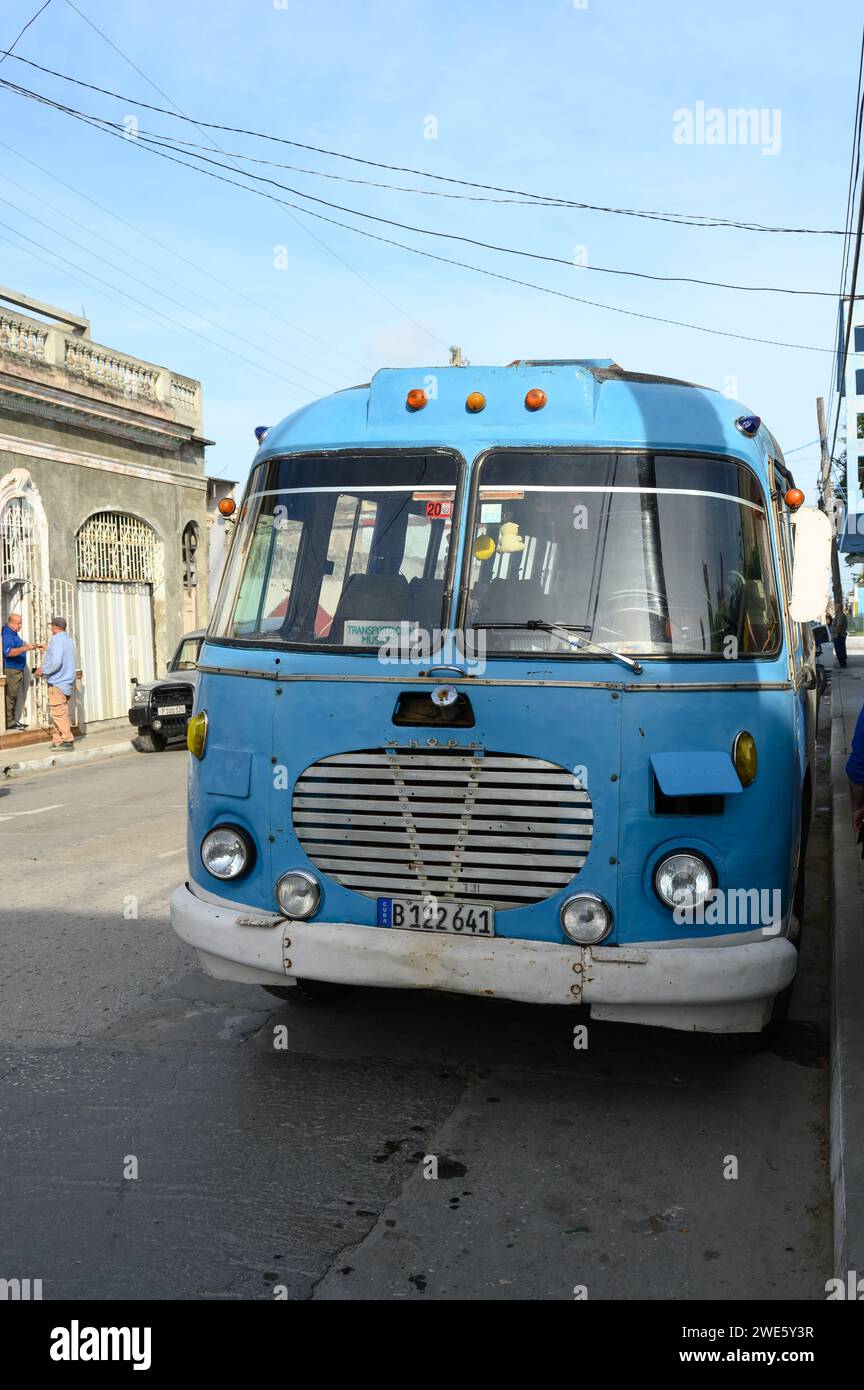 An old vintage bus is parked on Maceo Street. Front of the motor vehicle Stock Photo