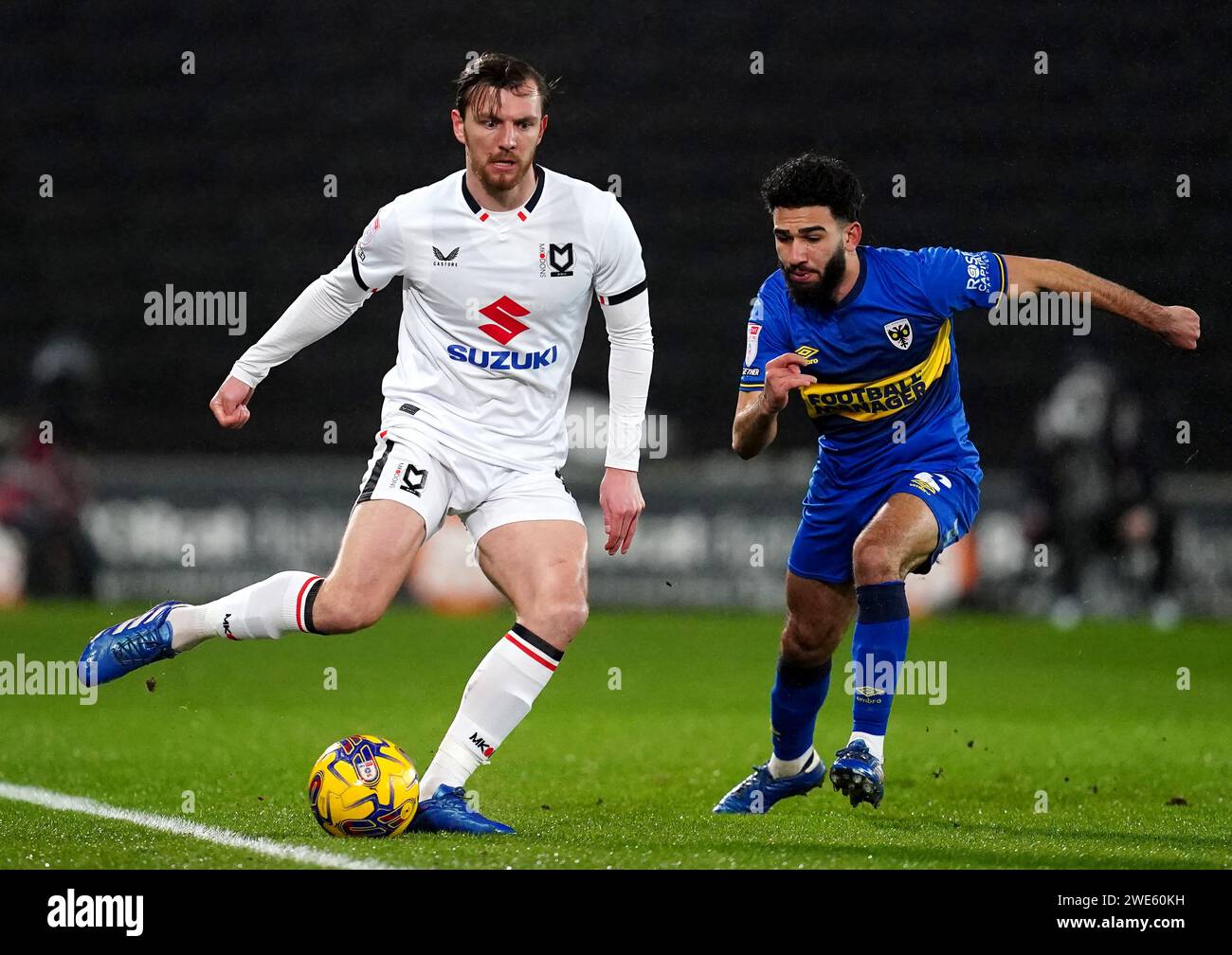 Milton Keynes Dons' Alex Gilbey (left) and AFC Wimbledon's Huseyin Biler battle for the ball during the Sky Bet League Two match at Stadium MK, Milton Keynes. Picture date: Tuesday January 23, 2024. Stock Photo