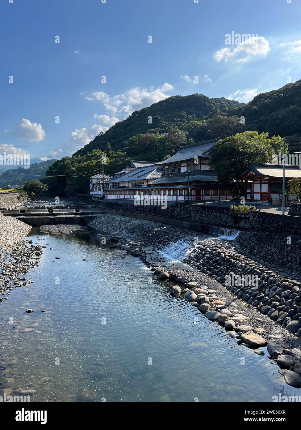 Traditional Japanese architecture in Yutoku Inari-jinja Shrine along the riverbank Stock Photo