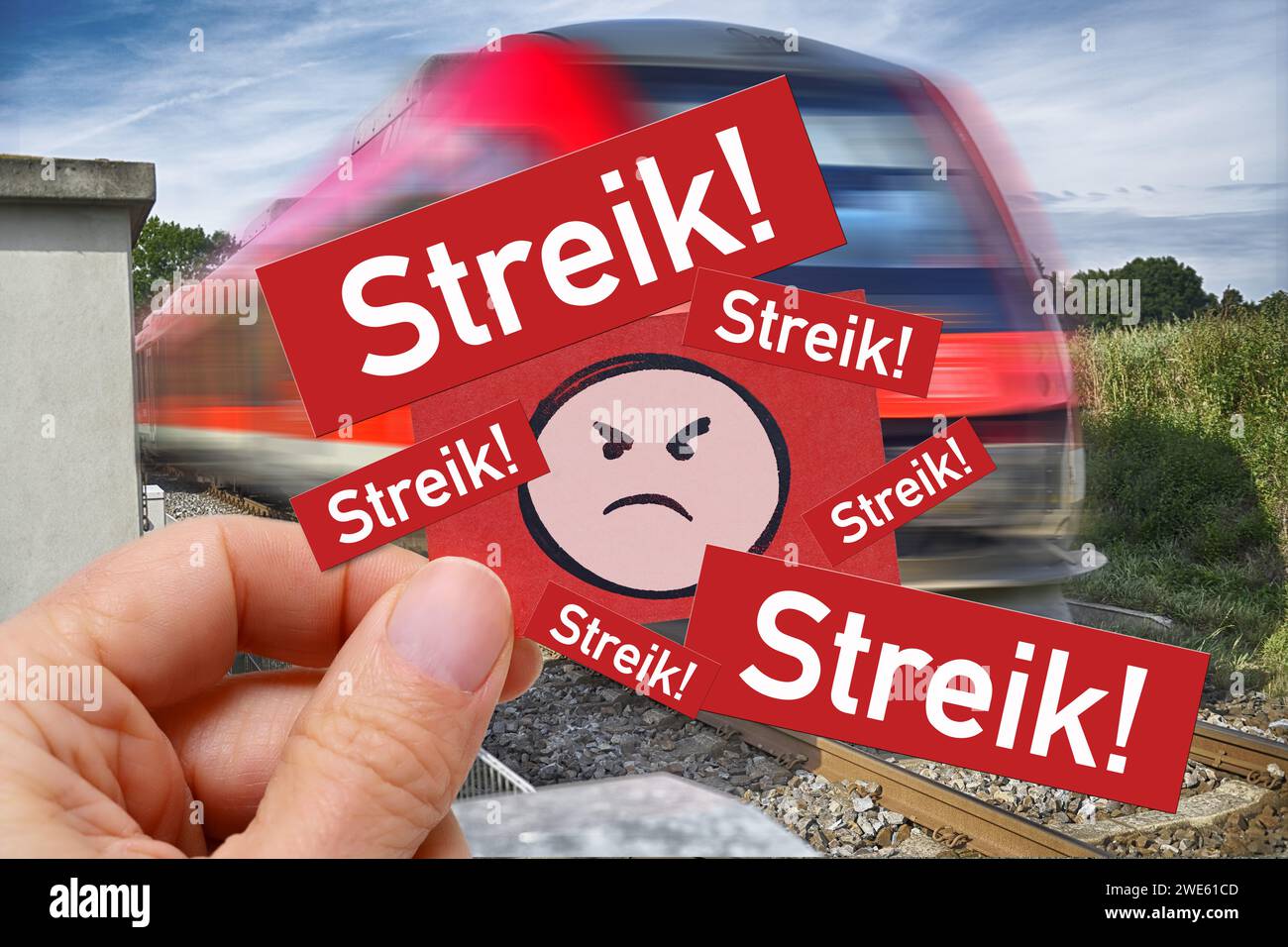 Hand Holds Note With Angry Emoji And Inscription Strike! Before Train, Symbol Photo Train Strike, Photo Montage Stock Photo