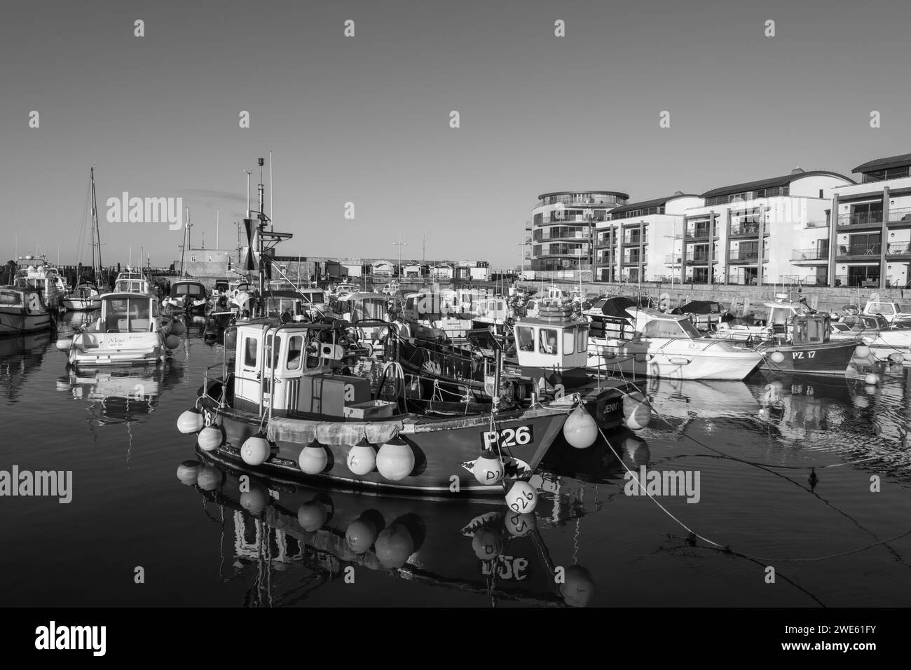 Fishing boats moored in West Bay harbour in Dorset Stock Photo - Alamy