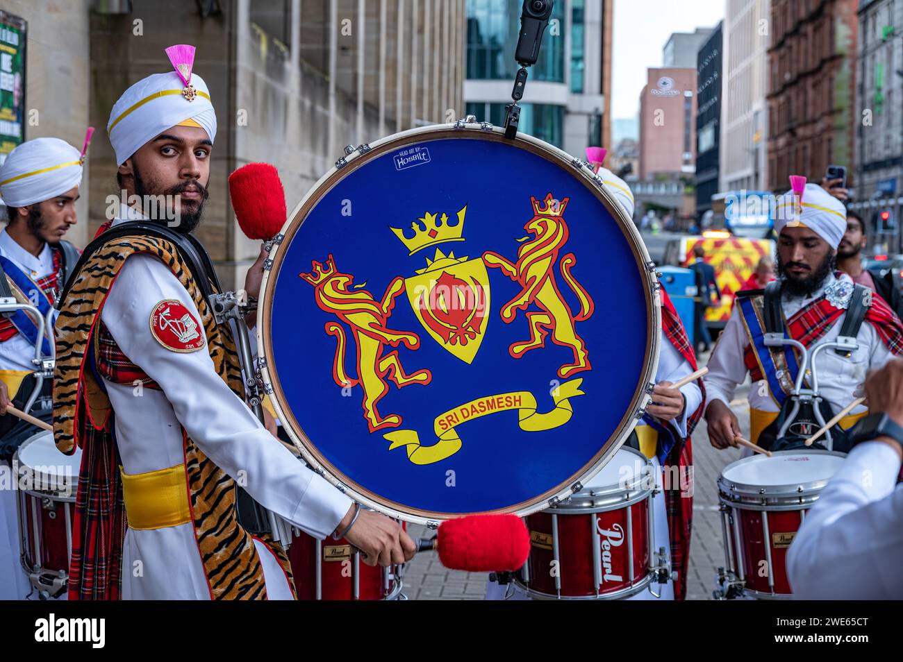 Drummesr from the Sri Dasmesh Pipe Band practicing outside Glasgow Royal Concert Hall during the week of the World Pipe Band Championships. Stock Photo