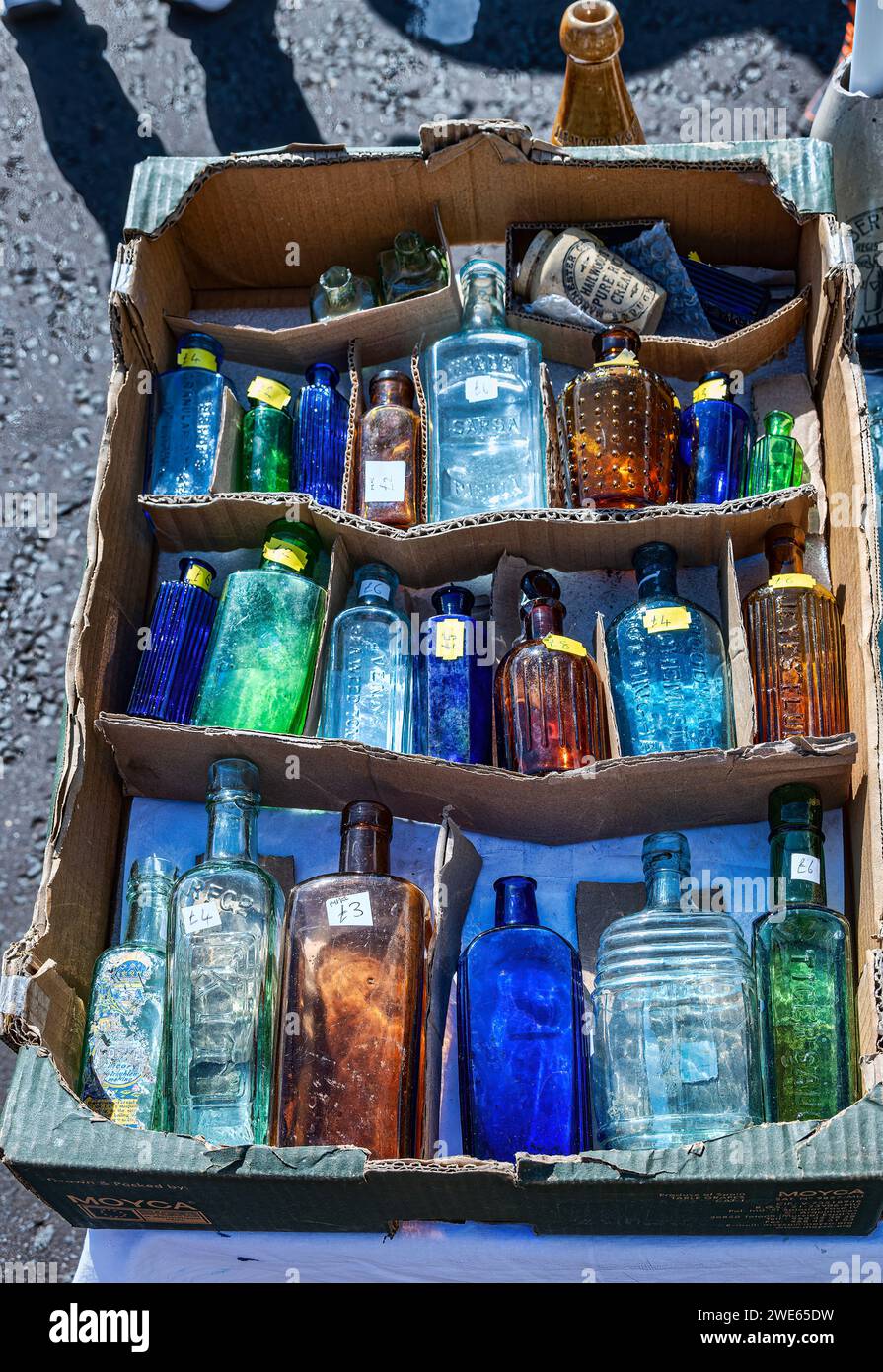 Market stall with selection of collectible of coloured bottles Stock