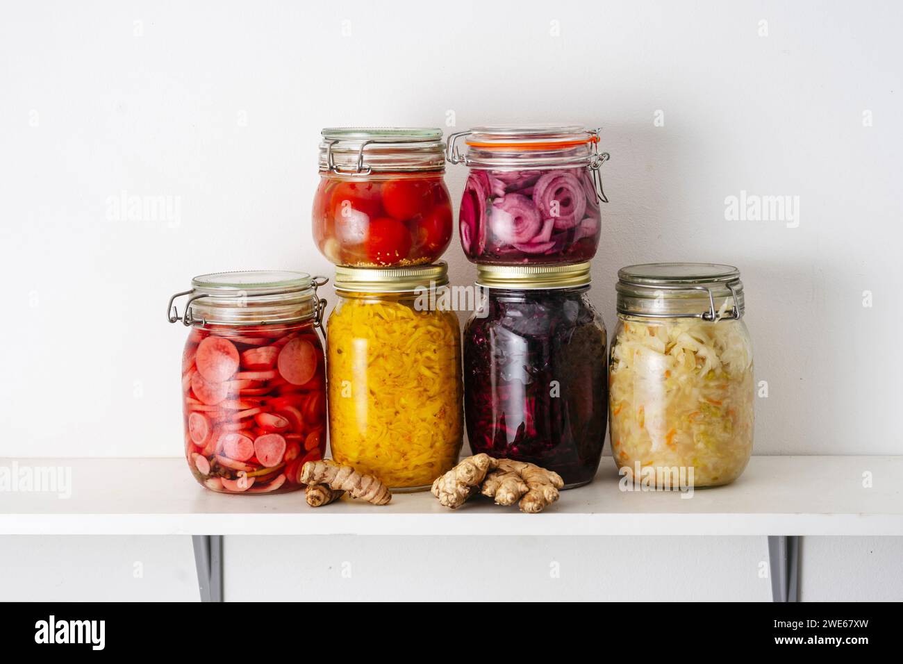 Jars with fermented vegetables on shelf at home Stock Photo