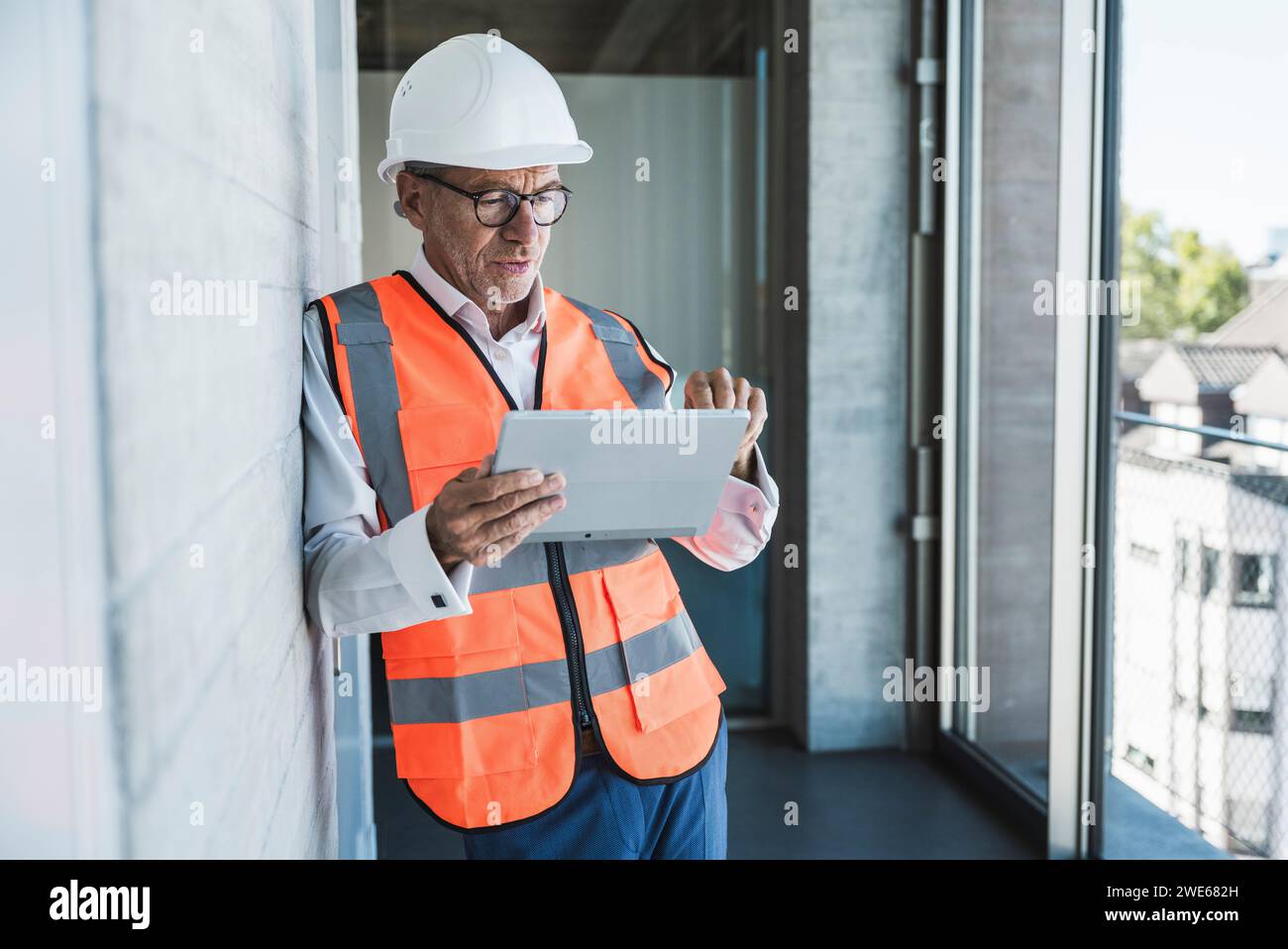 Engineer using tablet PC in corridor Stock Photo