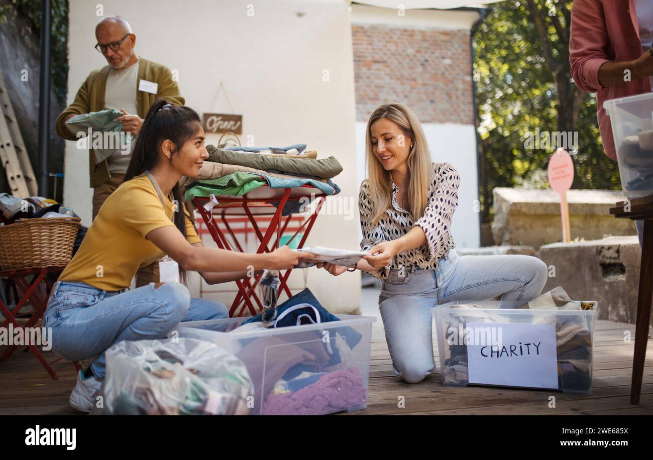 People collecting and sorting clothes for charity Stock Photo Alamy
