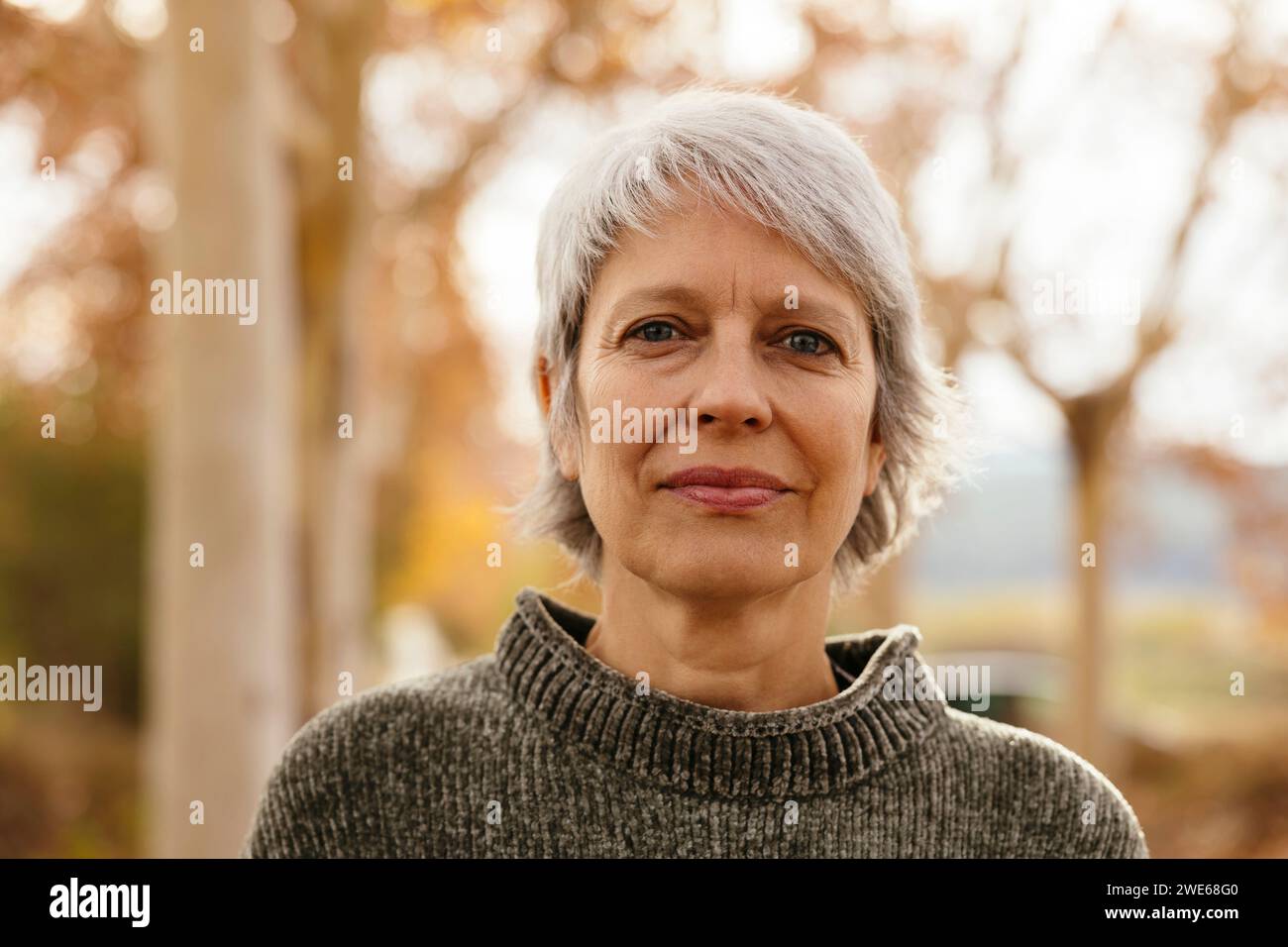 Smiling mature woman with short gray hair Stock Photo