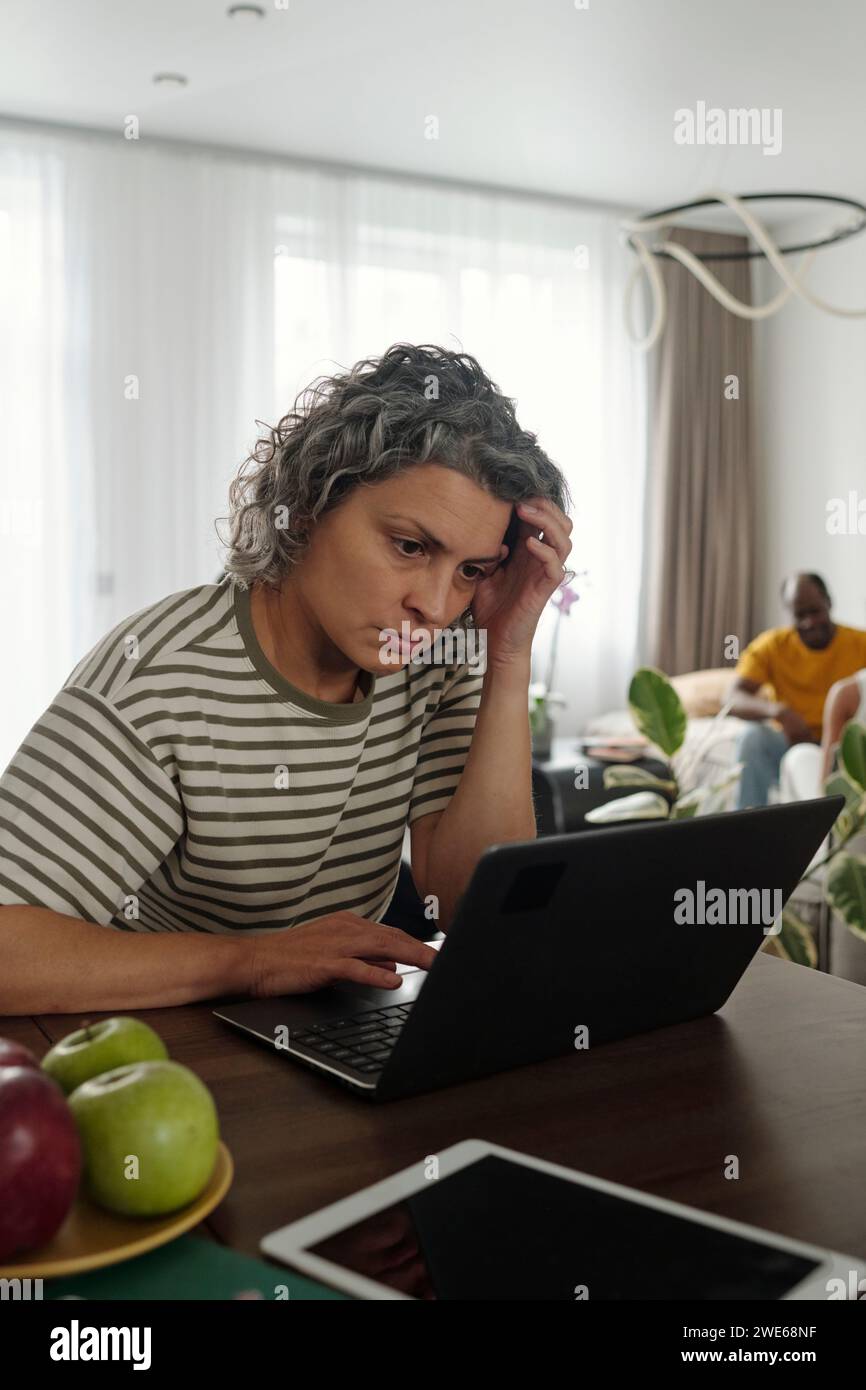 Woman using laptop and working from home Stock Photo
