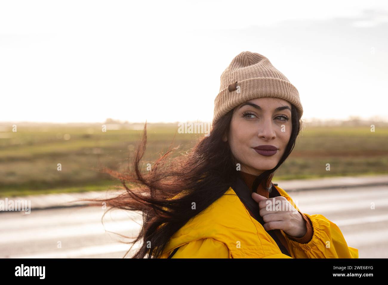 Beautiful woman with knit hat in front of sky Stock Photo