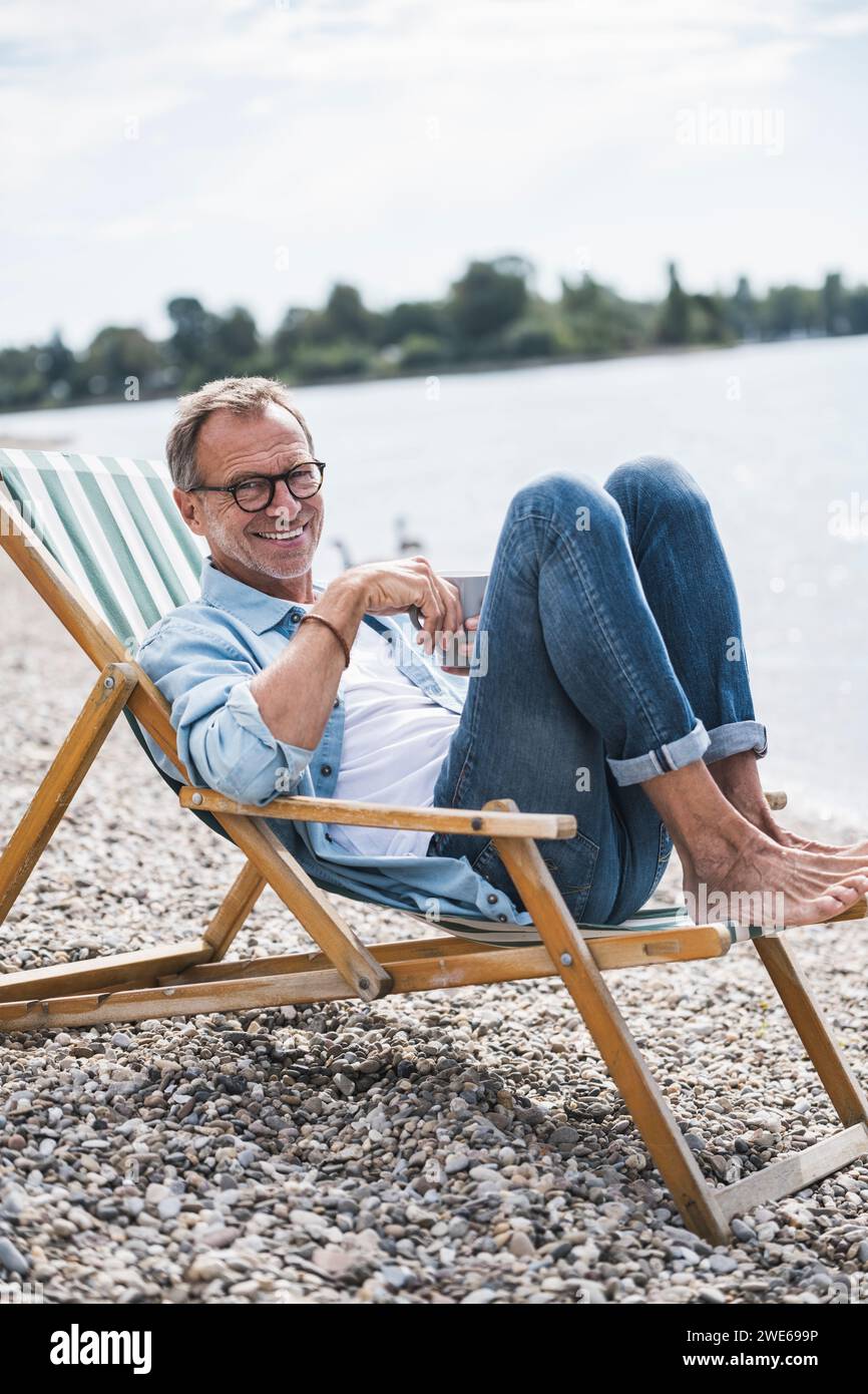 Man sitting chair full length hi-res stock photography and images - Alamy
