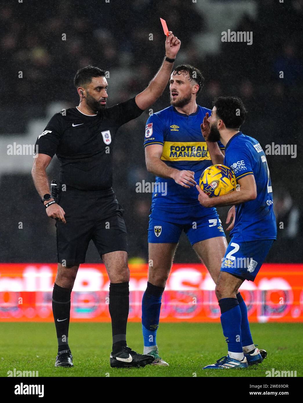 Referee Sunny Singh shows a red card to AFC Wimbledon's Huseyin Biler during the Sky Bet League Two match at Stadium MK, Milton Keynes. Picture date: Tuesday January 23, 2024. Stock Photo