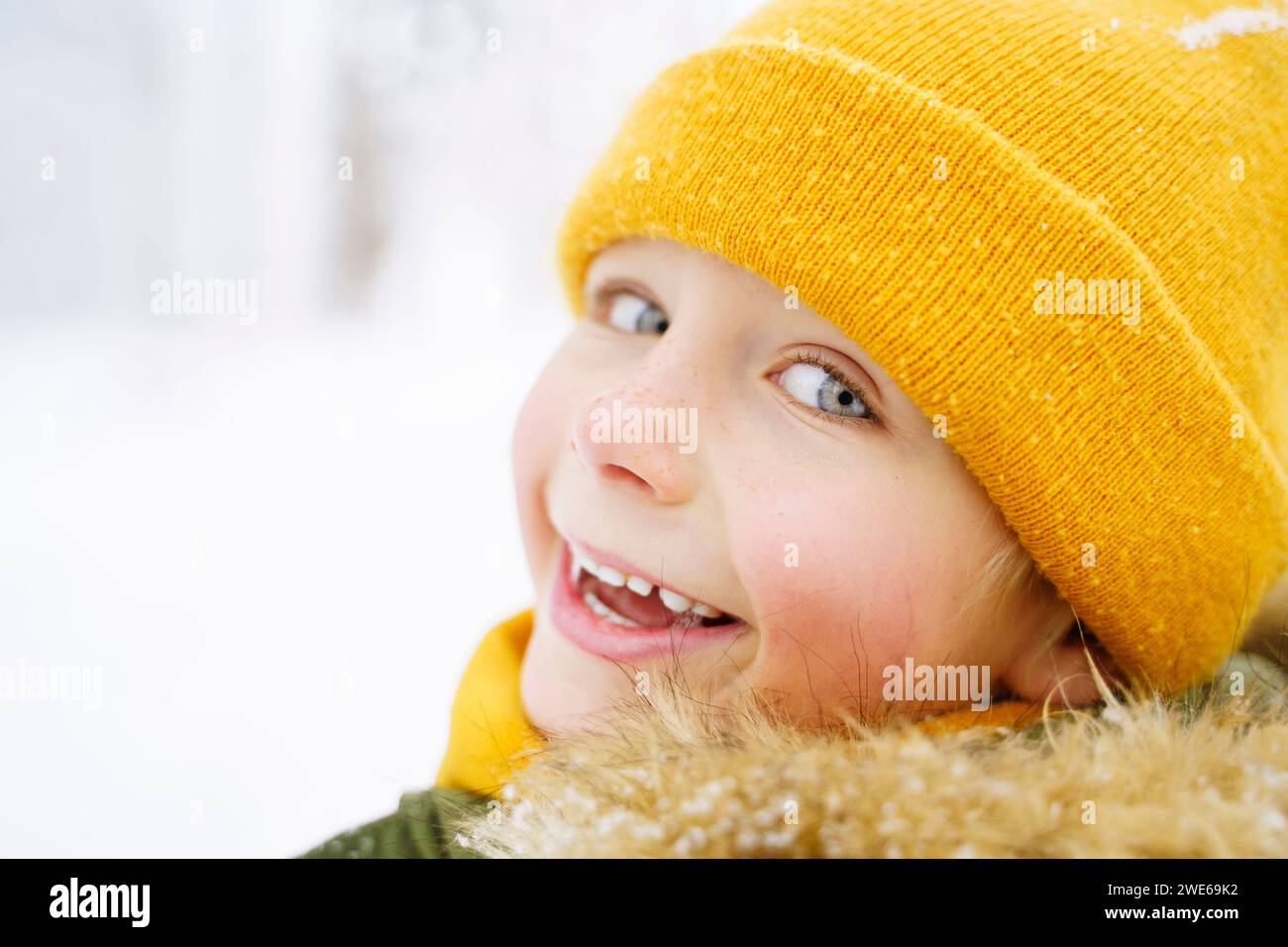 Happy boy wearing yellow knit hat Stock Photo