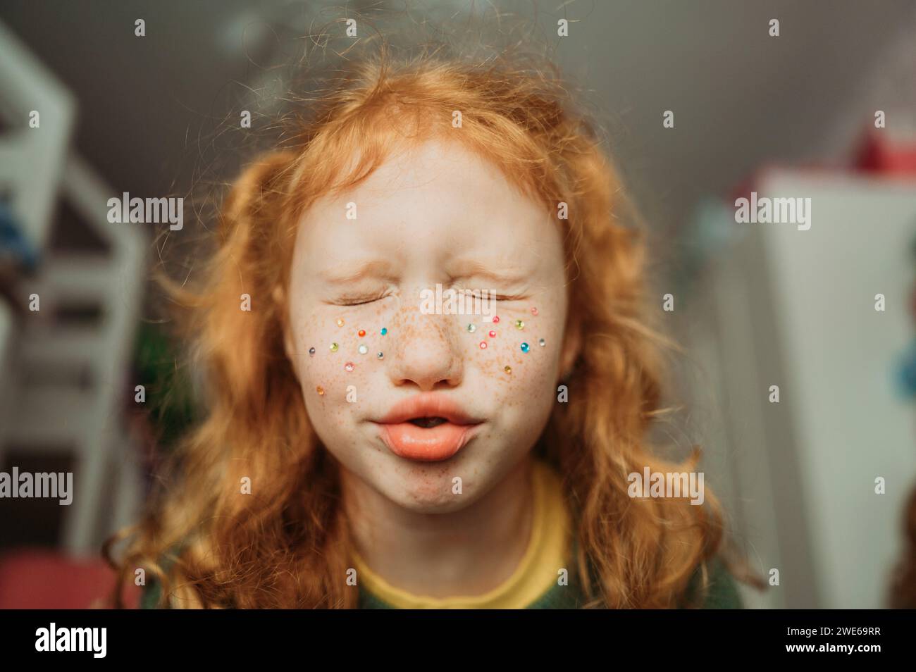 Redhead girl making facial expression at home Stock Photo