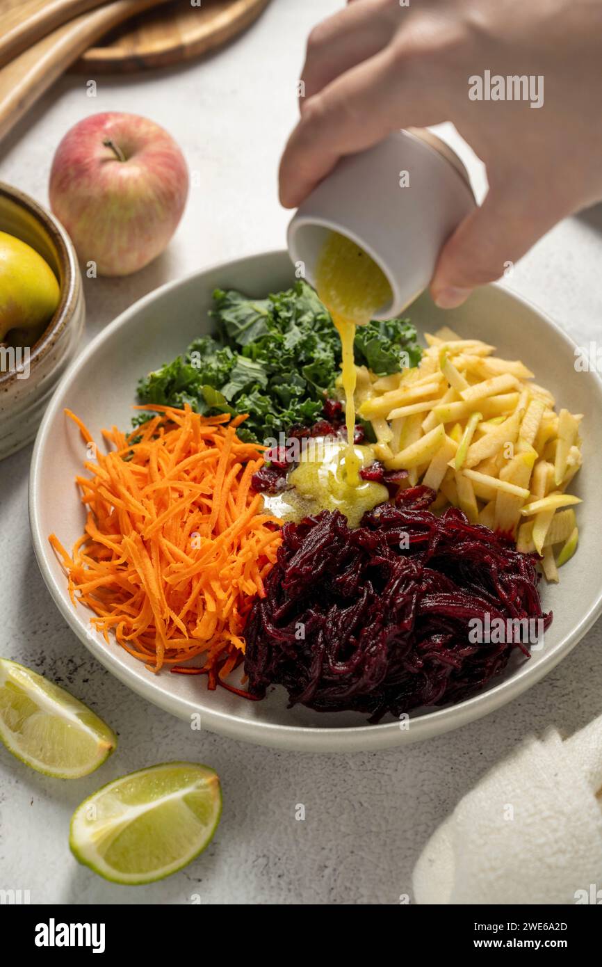 Raw vegetable plate with apple, beets, carrots, and kale Stock Photo