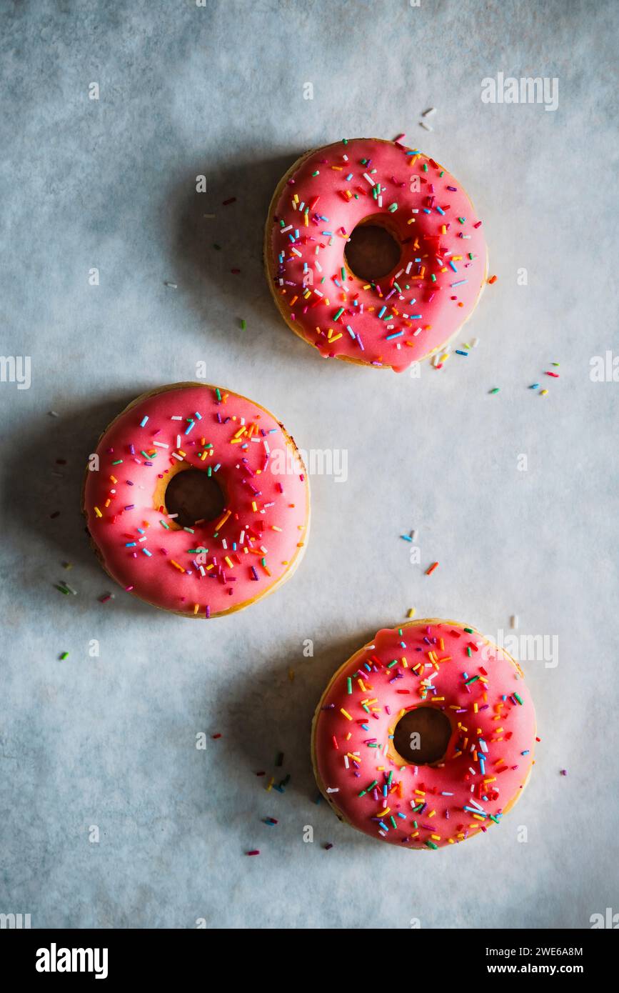 Donuts with pink icing and colored sugar sprinkles Stock Photo