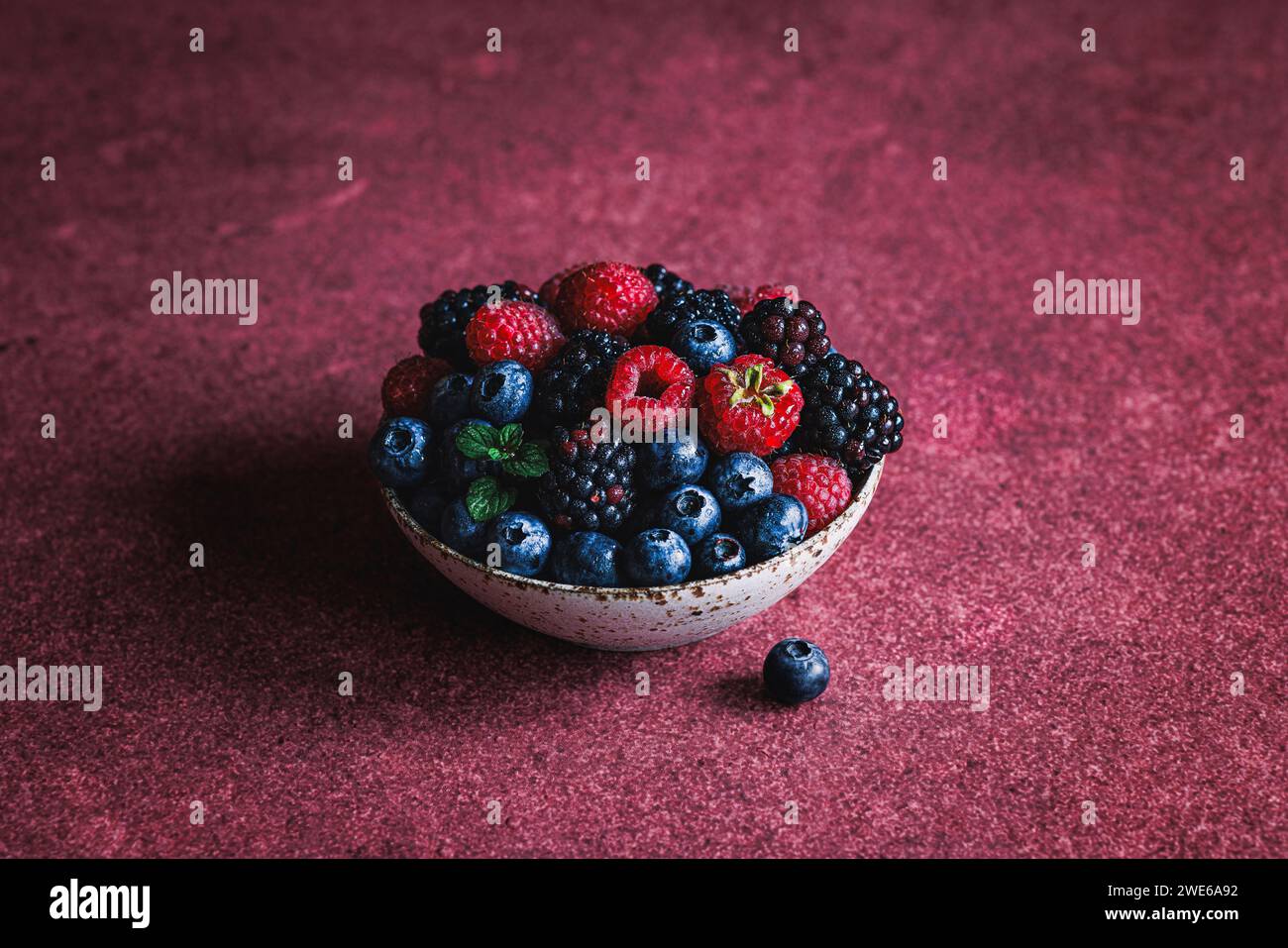 Mixed wild berries in a bowl Stock Photo