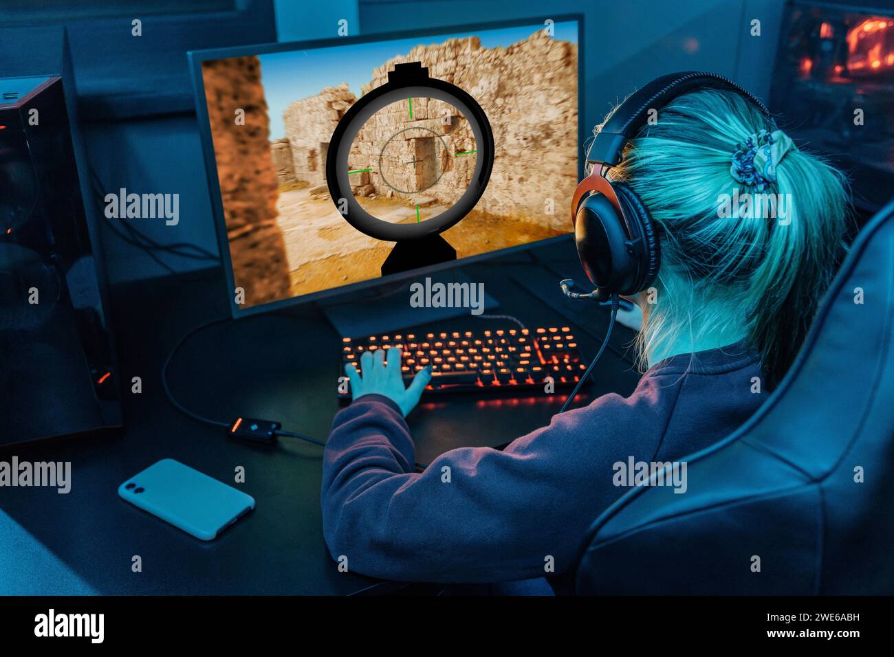 Gamer wearing headset and playing esports on desktop PC Stock Photo - Alamy