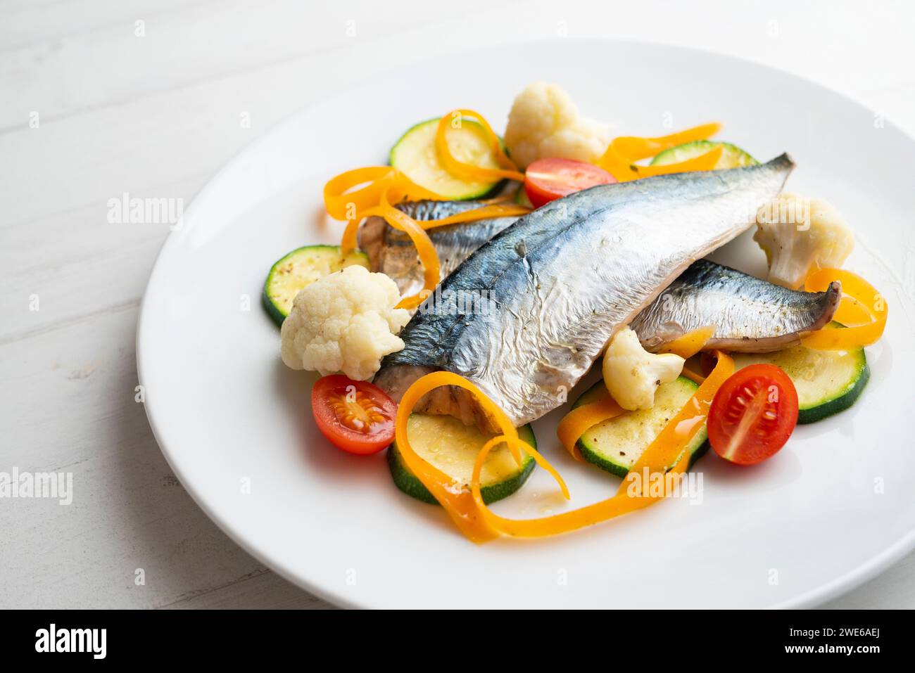 Baked mackerel with steamed vegetables Stock Photo