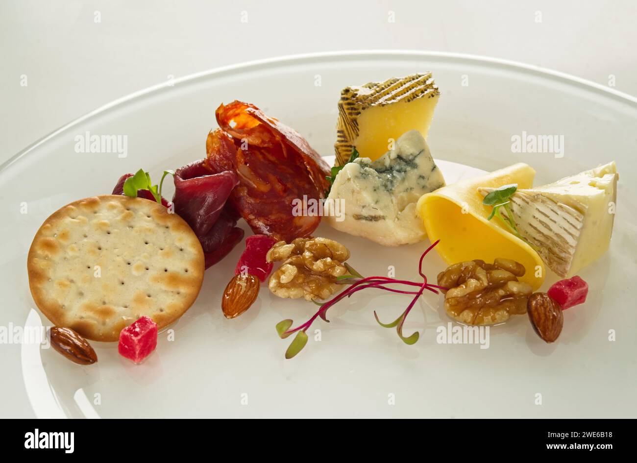 Cheese platter with roast beef, salami, nuts and crackers Stock Photo