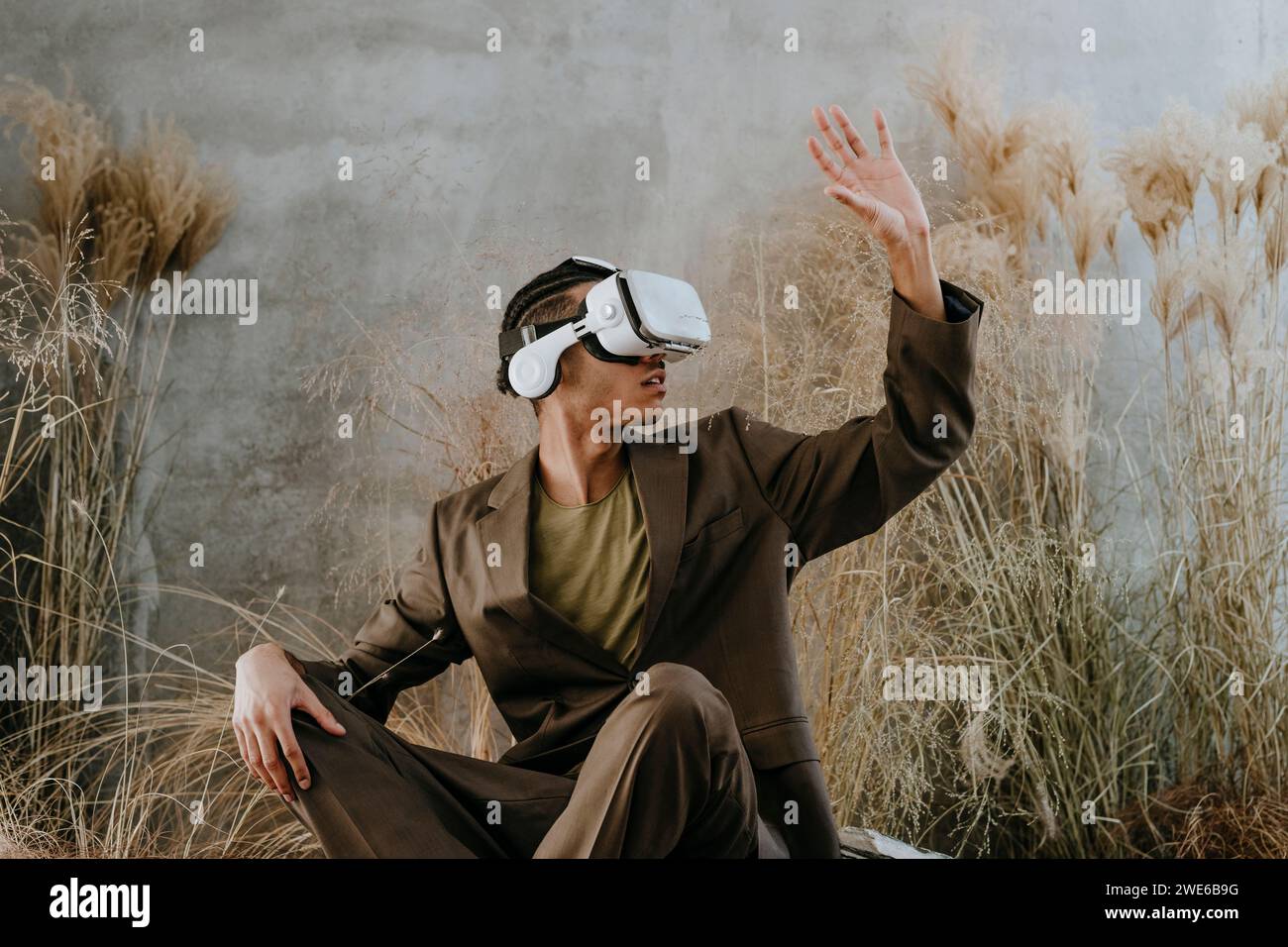 Businessman using virtual reality simulator and gesturing in garden Stock Photo