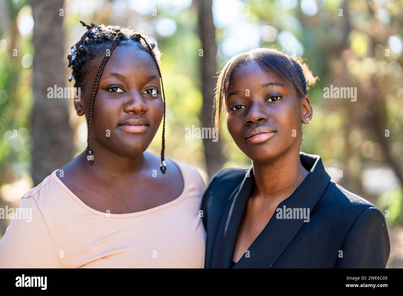 Young friends with black hair at park Stock Photo