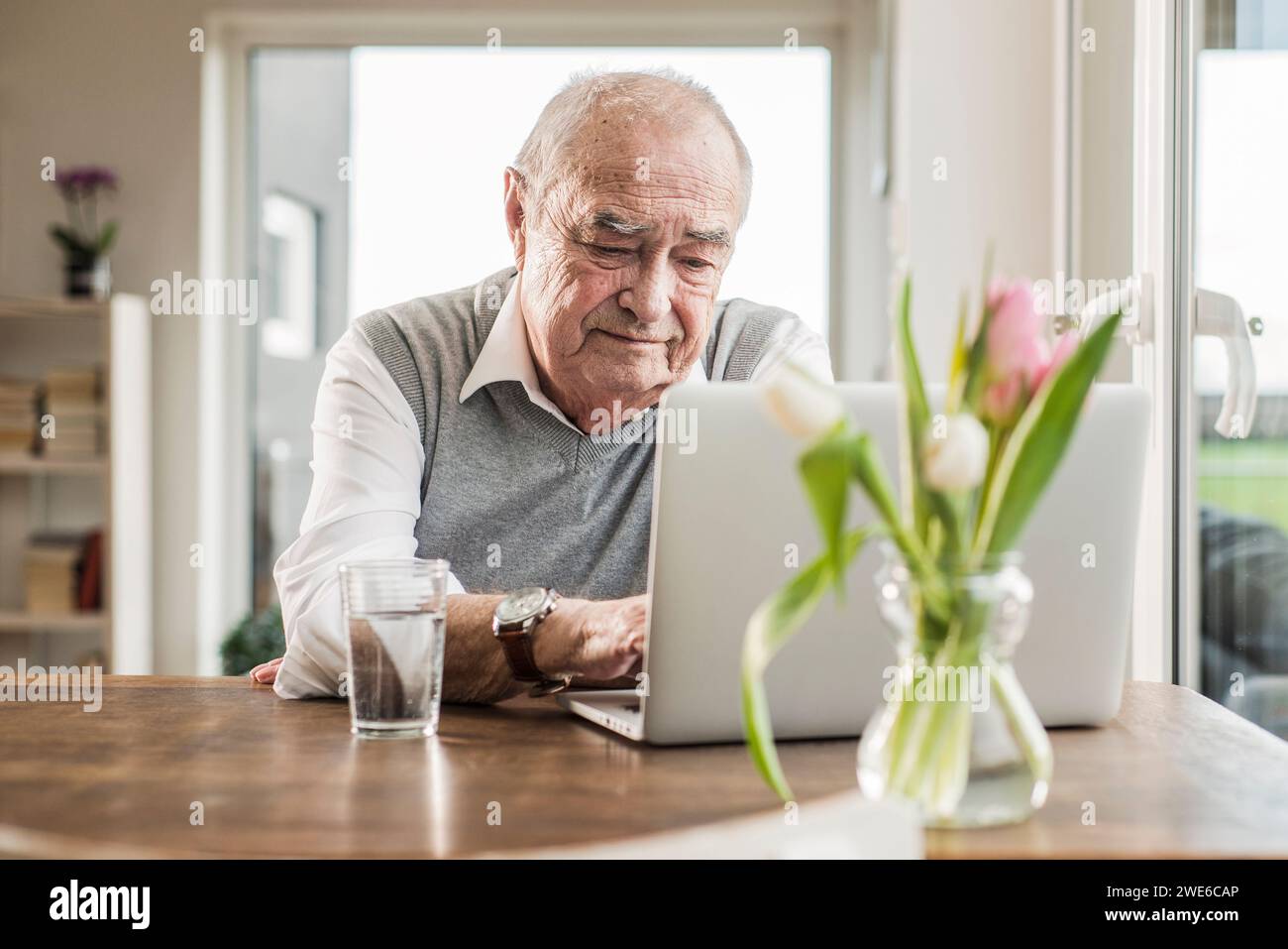 Senior man using laptop at home Stock Photo
