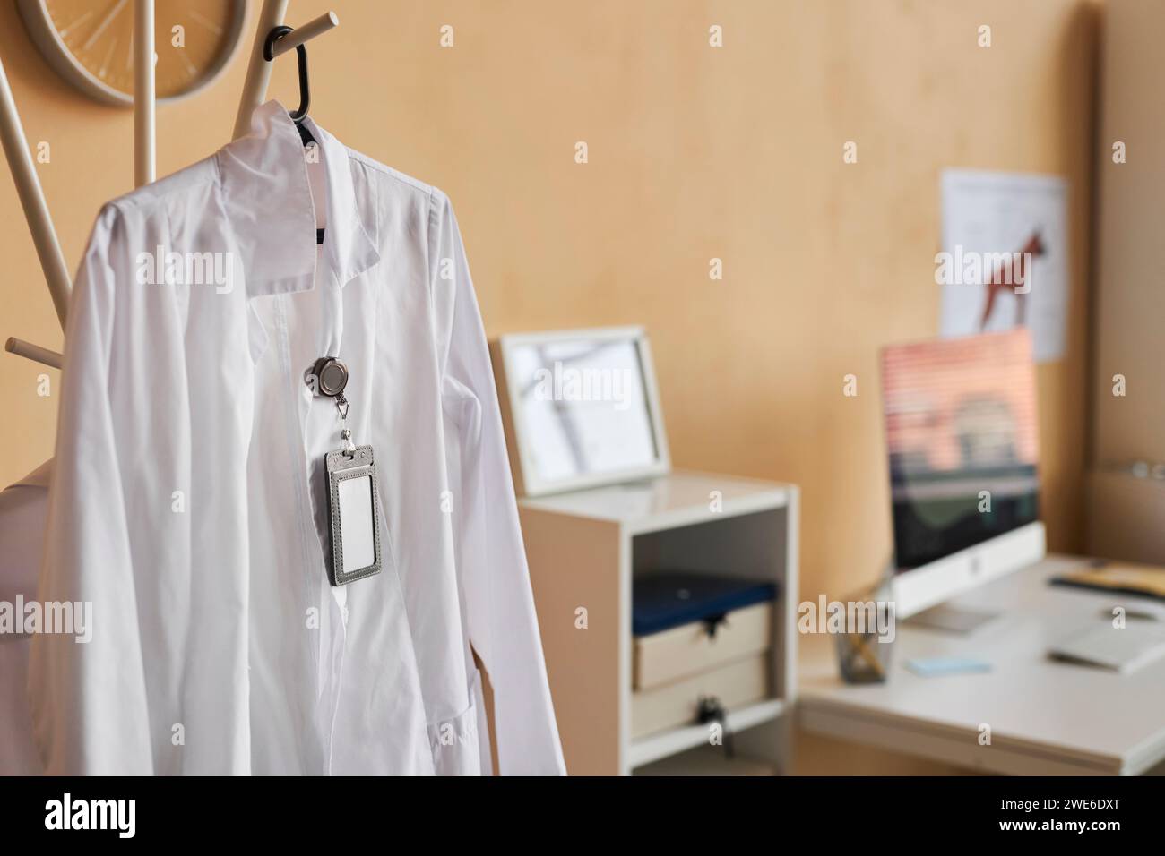 Lab coat hanging on clothes rack in veterinary clinic Stock Photo