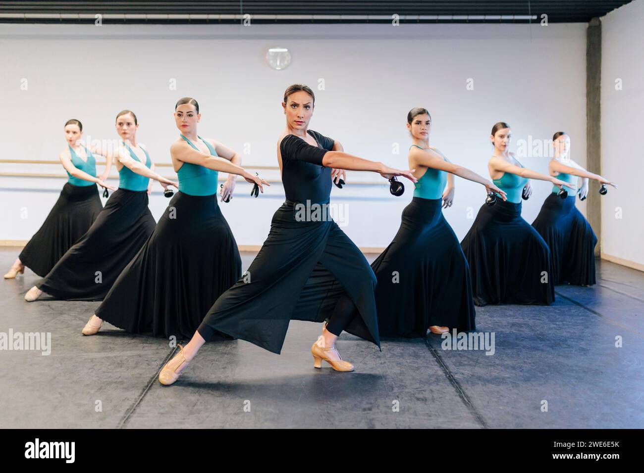 Confident instructor teaching flamenco dance to students at studio Stock Photo