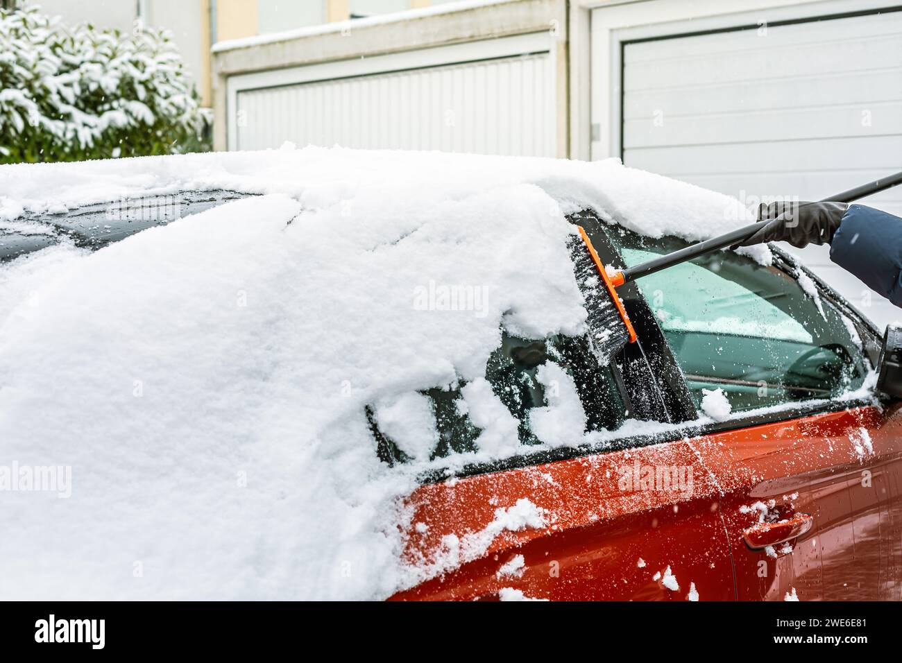 Cleaning snow from windshield. Cleaning and clearing the car from snow on a winter day Stock