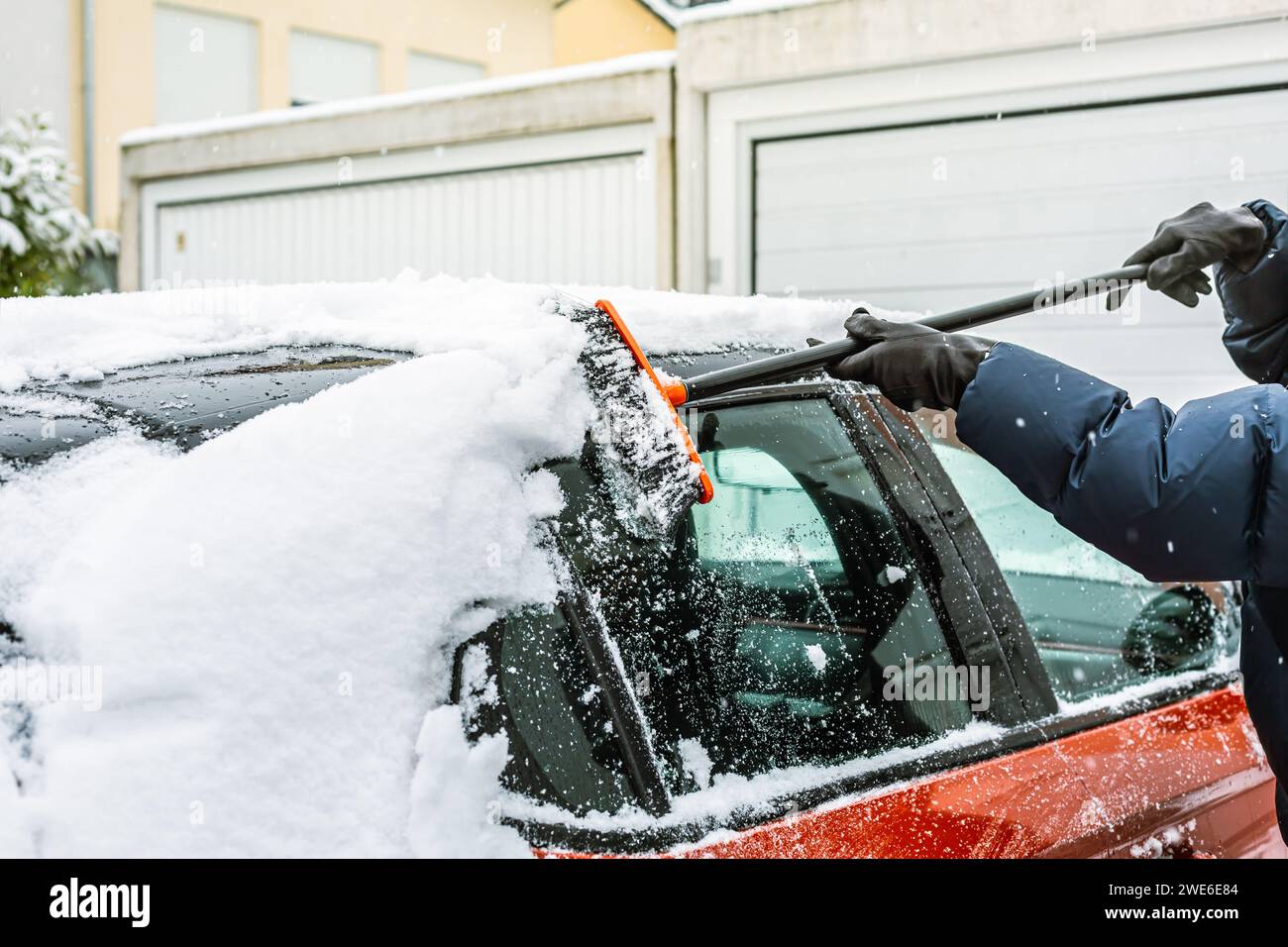 Cleaning snow from windshield. Cleaning and clearing the car from snow on a winter day Stock