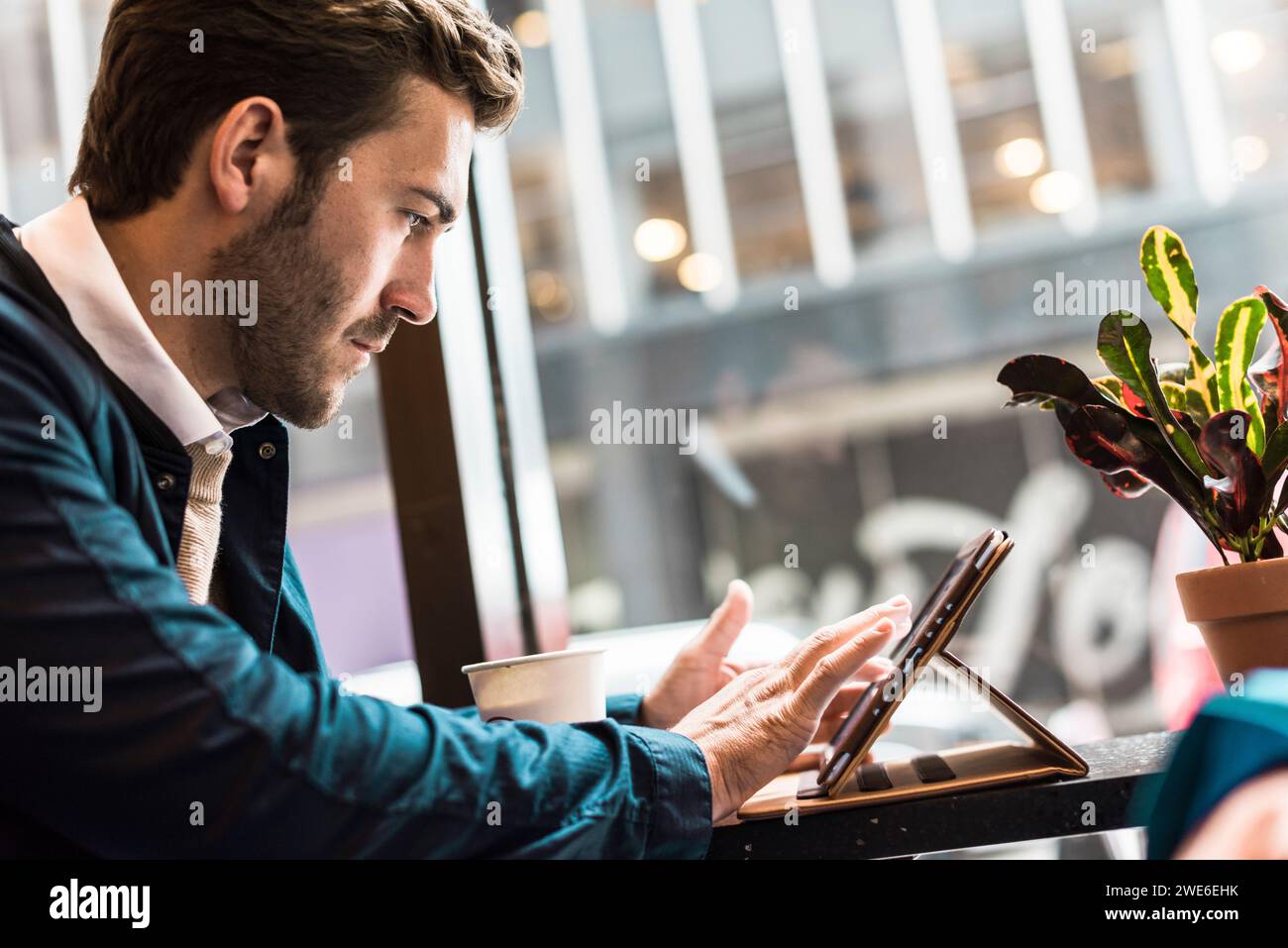 Businessman using tablet PC at cafe Stock Photo
